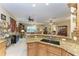 Open kitchen with granite island and views to living area at 1551 Atares Dr # 112, Punta Gorda, FL 33950
