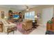 Cozy living room with comfortable seating, a large TV, and built-in shelving at 1551 Atares Dr # 112, Punta Gorda, FL 33950