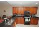 Modern kitchen with dark countertops and wood cabinets at 17074 Acapulco Rd # 112, Punta Gorda, FL 33955