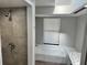 Bathroom with shower and a bathtub, gray tile at 17455 Masten Ave, Port Charlotte, FL 33954