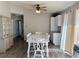 Bright dining room with white table and chairs, hardwood floors, and access to kitchen at 17455 Masten Ave, Port Charlotte, FL 33954