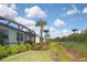 Landscaped backyard with tropical plants and a view of a home at 17764 Palmetto Pass Ln, Punta Gorda, FL 33982