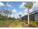 Landscaped backyard with a pathway and tropical plants at 17764 Palmetto Pass Ln, Punta Gorda, FL 33982