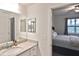 Bathroom with granite countertop, sink, and view into bedroom at 17764 Palmetto Pass Ln, Punta Gorda, FL 33982