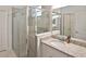 Modern bathroom with a walk-in shower and granite vanity at 17764 Palmetto Pass Ln, Punta Gorda, FL 33982