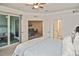 Spacious bedroom with access to a private balcony and en-suite bathroom at 17764 Palmetto Pass Ln, Punta Gorda, FL 33982