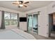 Bedroom with sliding door to private patio and TV at 17764 Palmetto Pass Ln, Punta Gorda, FL 33982