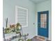 Front entry with blue door and potted plants at 17764 Palmetto Pass Ln, Punta Gorda, FL 33982