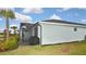Exterior view of a charming home with a screened patio and grill at 17764 Palmetto Pass Ln, Punta Gorda, FL 33982