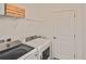 Bright laundry room with washer, dryer, and shelving at 17764 Palmetto Pass Ln, Punta Gorda, FL 33982