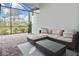 Relaxing patio with wicker furniture and screened enclosure at 17764 Palmetto Pass Ln, Punta Gorda, FL 33982