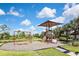 Community playground with swings, slides, and shaded area at 17764 Palmetto Pass Ln, Punta Gorda, FL 33982