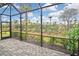 Enjoy the view from this screened patio, complete with string lights at 17764 Palmetto Pass Ln, Punta Gorda, FL 33982