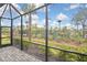 Spacious screened patio with pavers and a tranquil view at 17764 Palmetto Pass Ln, Punta Gorda, FL 33982