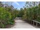 Park trail leading to a calm body of water at 1845 Edison Dr, Englewood, FL 34224