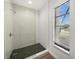 Modern bathroom with a herringbone-tiled shower and window at 1849 Jamaica Way, Punta Gorda, FL 33950