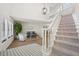 Bright entryway with staircase, sitting area, and patterned tile floor at 1849 Jamaica Way, Punta Gorda, FL 33950