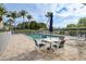 Relaxing community pool with patio furniture and umbrellas at 200 Harbor Walk Dr # 144, Punta Gorda, FL 33950