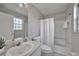 Clean bathroom with white tile and a bathtub shower at 20037 Sancraft Ave, Port Charlotte, FL 33954