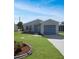 Newly renovated home with a landscaped front yard and attached garage at 20037 Sancraft Ave, Port Charlotte, FL 33954