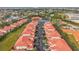 Aerial view of condo community near water, featuring tennis courts and ample parking at 240 W End Dr # 1011, Punta Gorda, FL 33950