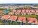 Aerial view of condo community with tennis courts, and spacious green areas at 240 W End Dr # 1011, Punta Gorda, FL 33950