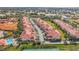 Aerial view of condo complex near water, highlighting buildings, pool, and tennis courts at 240 W End Dr # 1011, Punta Gorda, FL 33950