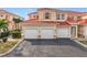 Three-car garage with a tan stucco exterior at 240 W End Dr # 1011, Punta Gorda, FL 33950