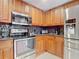 Kitchen with stainless steel appliances and wood cabinets at 240 W End Dr # 1011, Punta Gorda, FL 33950