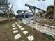 Outdoor kitchen and pergola with stone pathway at 2474 Como St, Port Charlotte, FL 33948