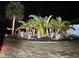 Lush tropical landscaping in the front yard at night at 2474 Como St, Port Charlotte, FL 33948