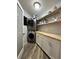 Laundry room with stacked washer and dryer and custom cabinetry at 2474 Como St, Port Charlotte, FL 33948