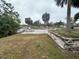 Spacious backyard patio with stone wall at 2474 Como St, Port Charlotte, FL 33948