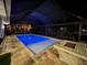 Relaxing covered pool and patio area at night at 2474 Como St, Port Charlotte, FL 33948