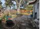 Large backyard with patio, established trees, and a grassy area at 2488 Warne St, Port Charlotte, FL 33952