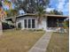 Cute bungalow-style home with a well-maintained lawn and walkway at 2488 Warne St, Port Charlotte, FL 33952