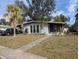 Gray house with palm trees and a walkway leading to the entrance at 2488 Warne St, Port Charlotte, FL 33952