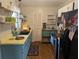 Charming kitchen with teal cabinets and a yellow countertop at 2488 Warne St, Port Charlotte, FL 33952