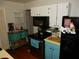 White cabinets and teal lower cabinets in this kitchen at 2488 Warne St, Port Charlotte, FL 33952