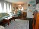 Cozy living room featuring a teal couch and a dark wood floor at 2488 Warne St, Port Charlotte, FL 33952