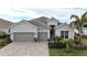 Two-story home with gray siding, gray roof, and a two-car garage at 25073 Golden Fern Dr, Punta Gorda, FL 33955