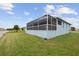 Screened porch overlooking a grassy backyard at 27 Meadowlark Ln, Placida, FL 33946