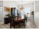 Formal dining room with hardwood floors, oval table, and chandelier at 27 Meadowlark Ln, Placida, FL 33946