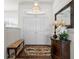 Bright entryway with hardwood floors, bench, and decorative mirror at 27 Meadowlark Ln, Placida, FL 33946