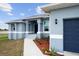 House exterior showcasing entryway, landscaping, and garage at 27 Meadowlark Ln, Placida, FL 33946