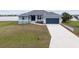 Single-story house with a two-car garage and lake view at 27 Meadowlark Ln, Placida, FL 33946