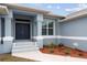 Home's entryway with double doors and landscaping at 27 Meadowlark Ln, Placida, FL 33946
