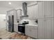 Modern kitchen with stainless steel appliances and gray cabinets at 27 Meadowlark Ln, Placida, FL 33946