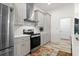 Modern kitchen with stainless steel appliances and gray cabinets at 27 Meadowlark Ln, Placida, FL 33946