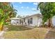 White house with a backyard patio and landscaping at 28434 Sabal Palm Dr, Punta Gorda, FL 33982